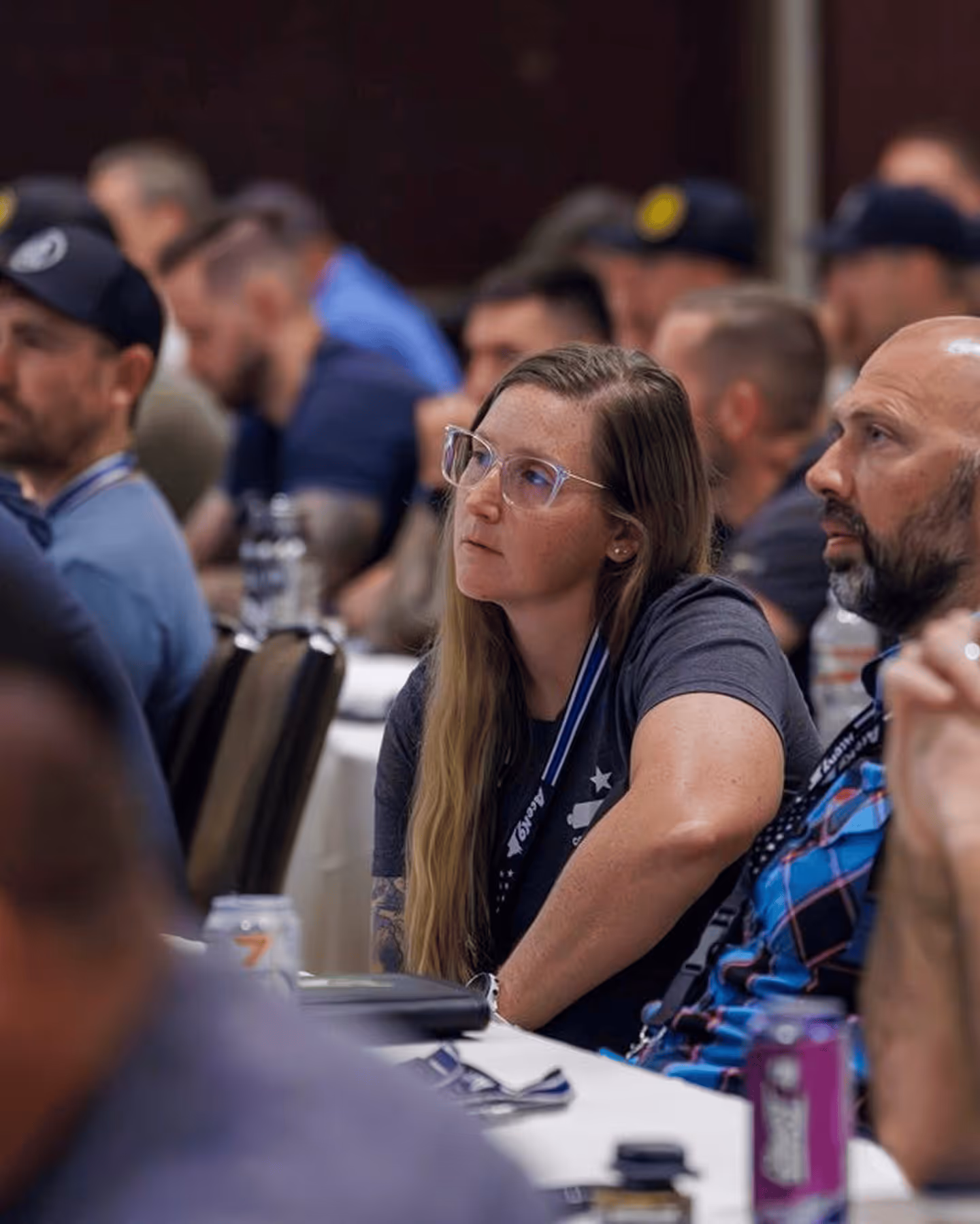 K-9 handlers listening intently during a training seminar session at the HITS conference