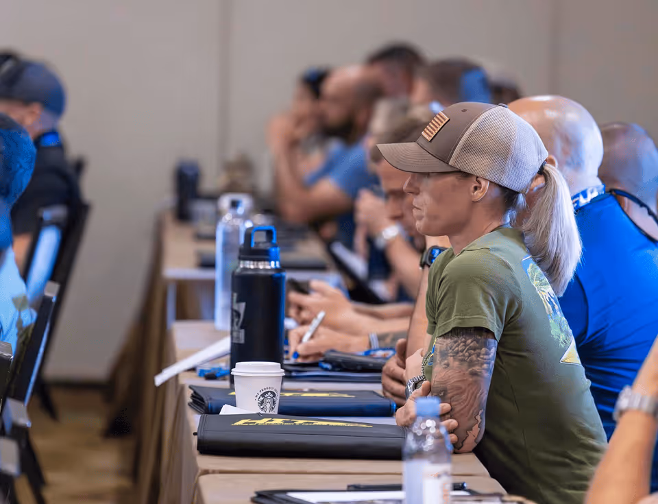 K-9 handler taking notes during an instruction block at a HITS training seminar