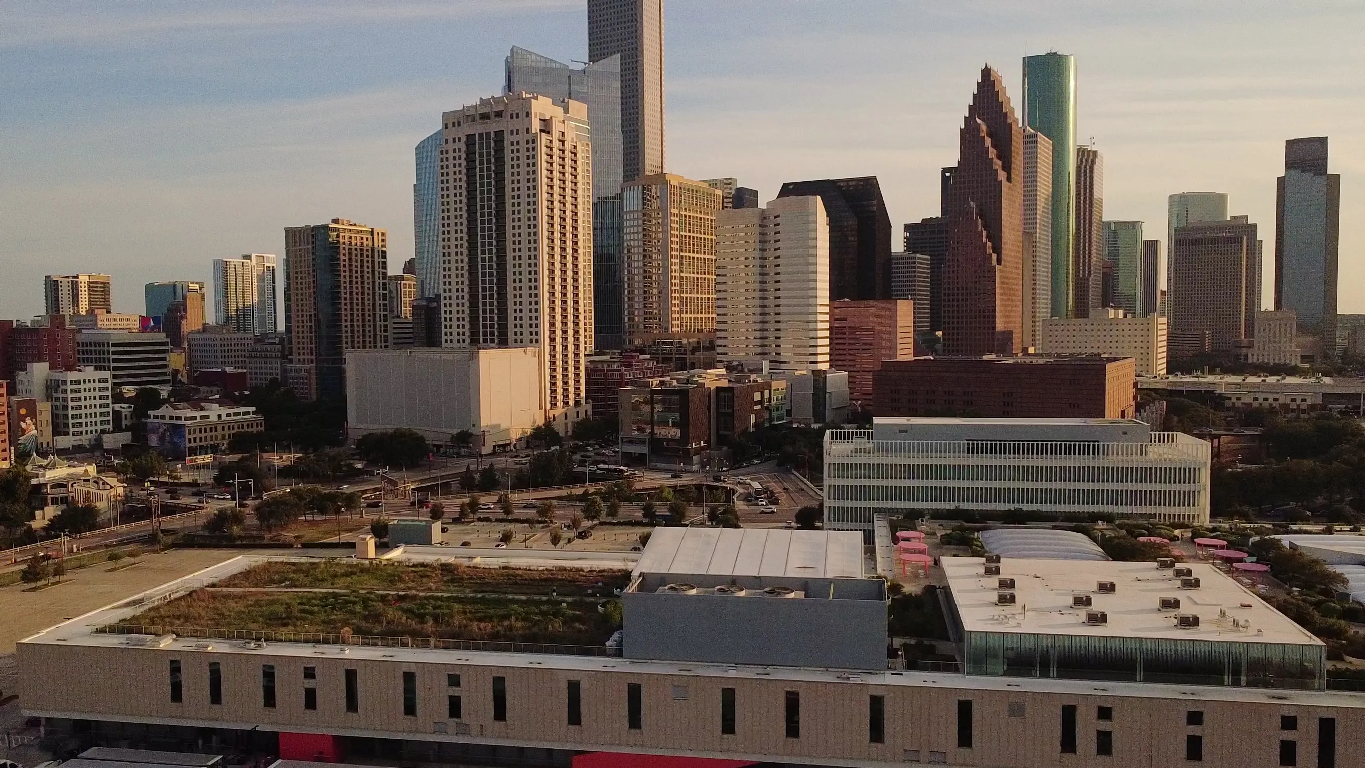 Aerial view of the Blackwood Skyfarm on the roof of POST Houston, with the downtown Houston skyline behind it