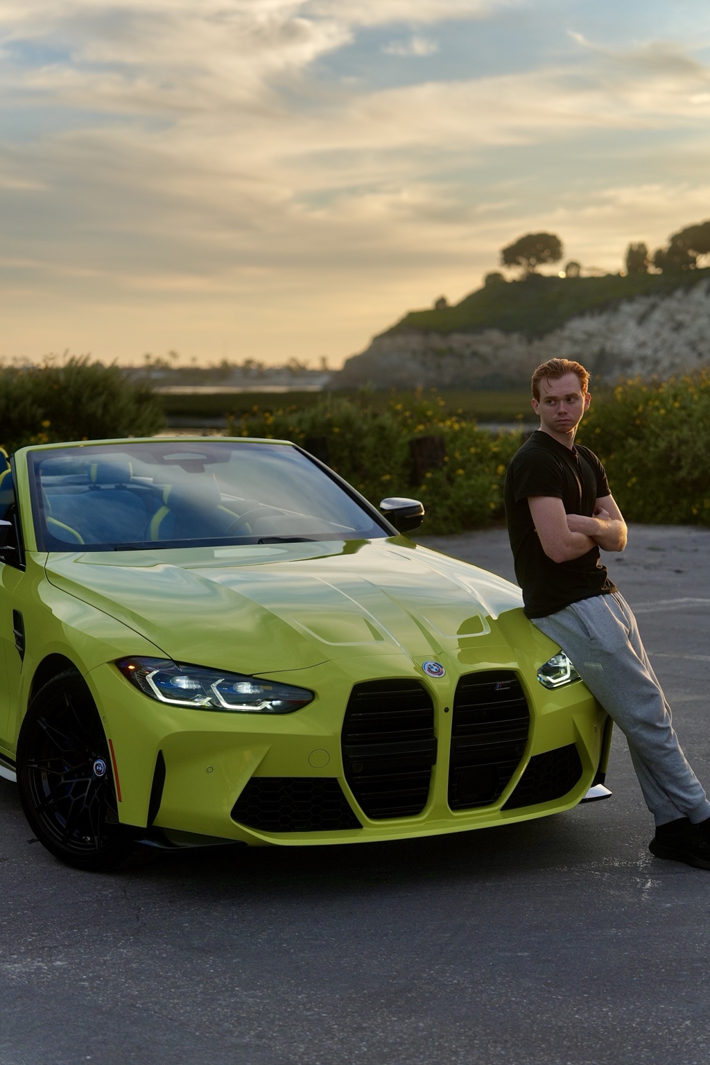 Ken Van Vorhis, founder of Prometheus Exotics, beside a BMW M4 Competition at sunset in Newport Beach