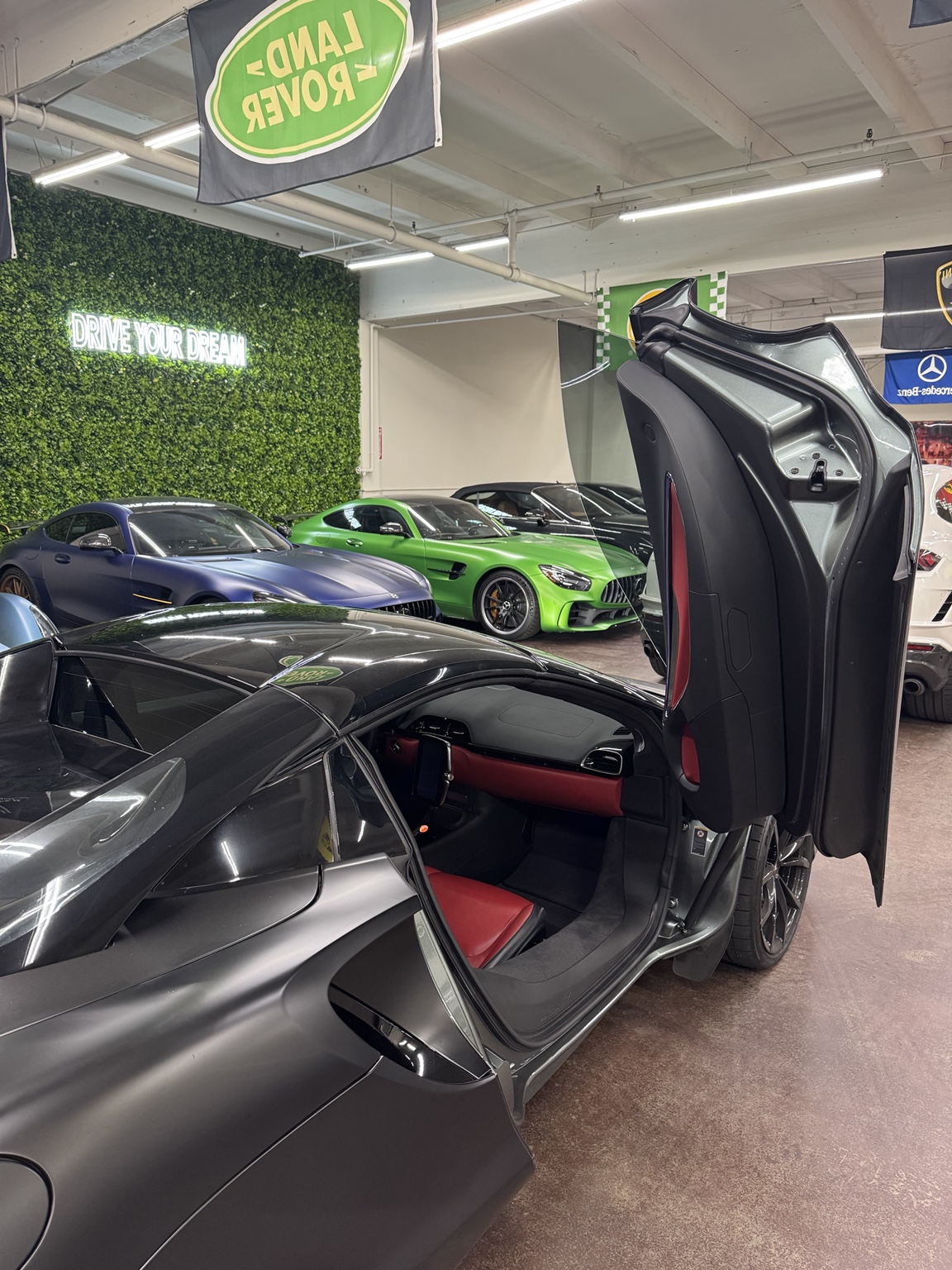 An exotic car with its door raised inside the Southern California warehouse where the Prometheus Exotics fleet is kept
