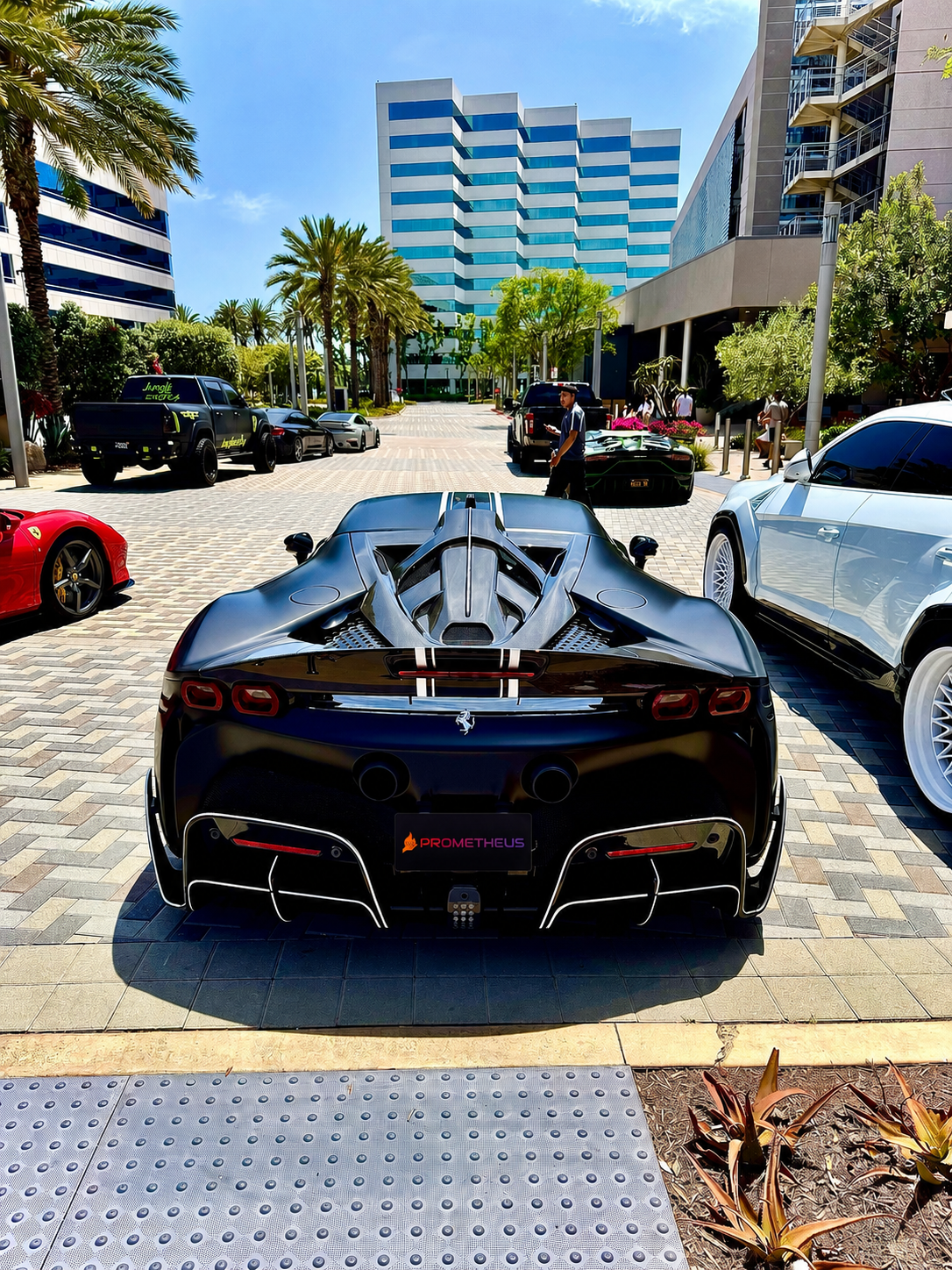 A black Ferrari carrying the Prometheus Exotics decal parked outside an office tower in Orange County, California