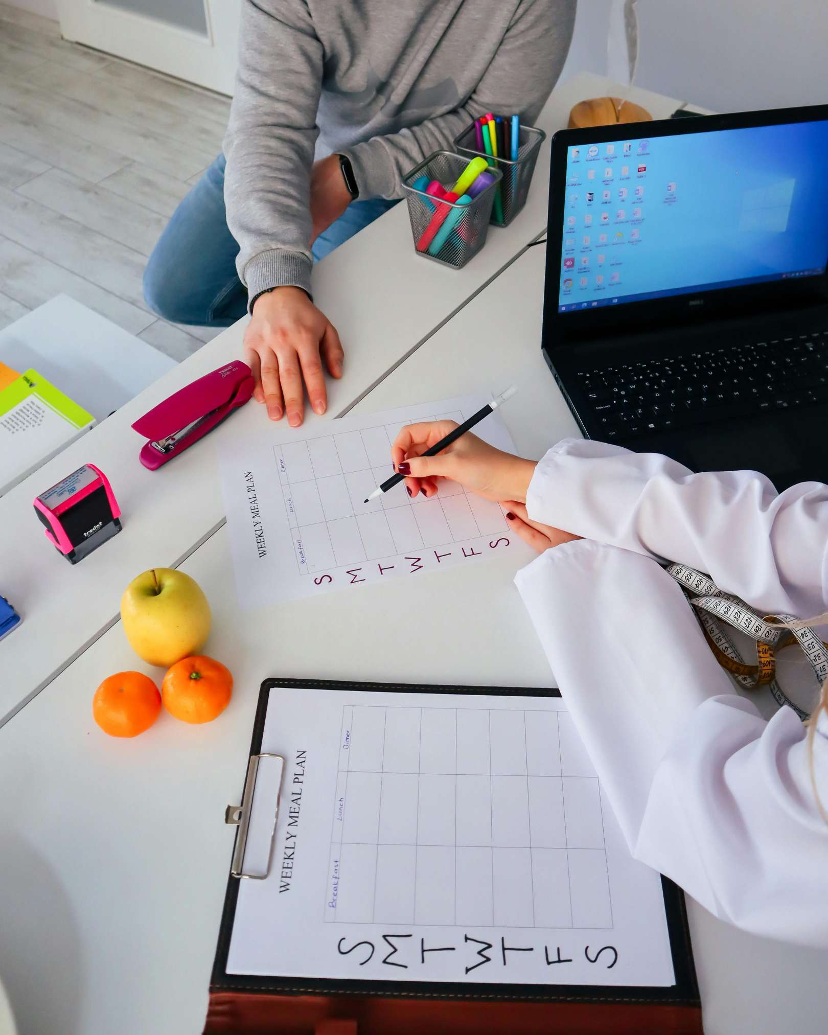 Sports nutrition professionals reviewing meal plans at a desk