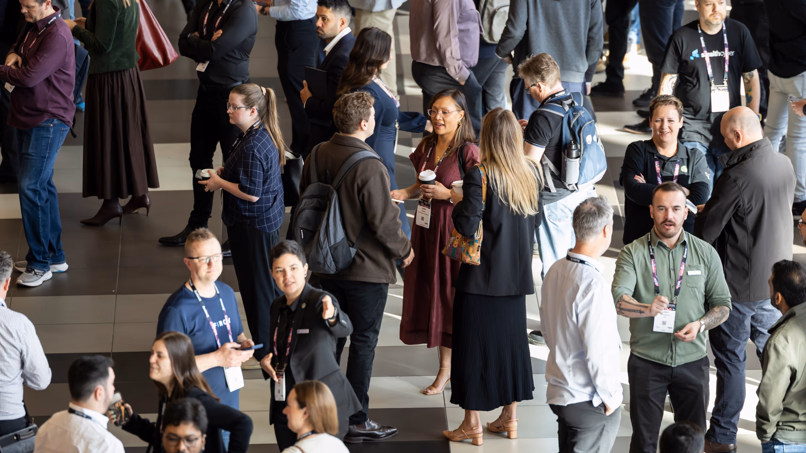 Delegates networking in the foyer at CyberCon