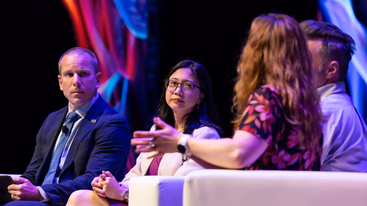 Panellists in discussion on stage at CyberCon