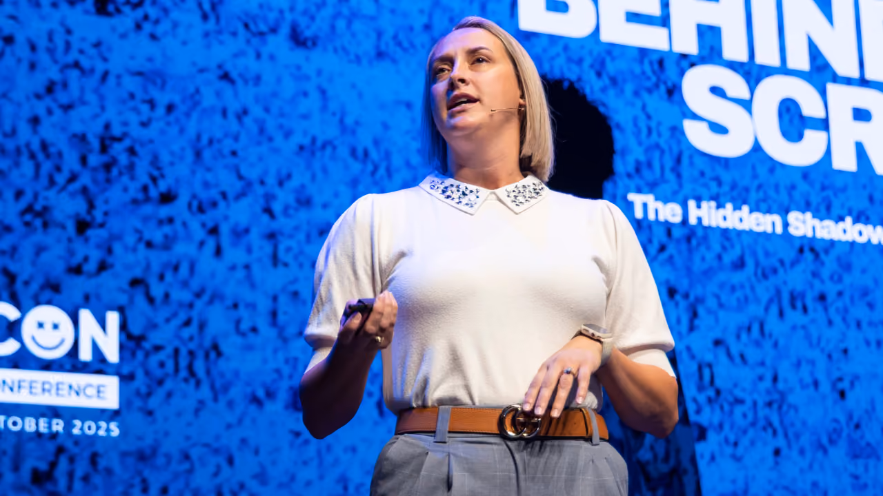 Speaker presenting on stage at CyberCon