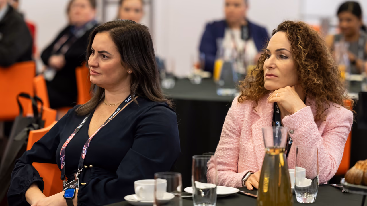 Two delegates listening during a CyberCon table session