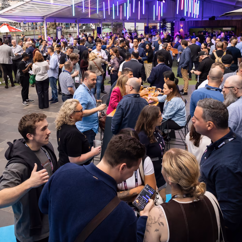 Delegates mingling over drinks at the CyberCon block party
