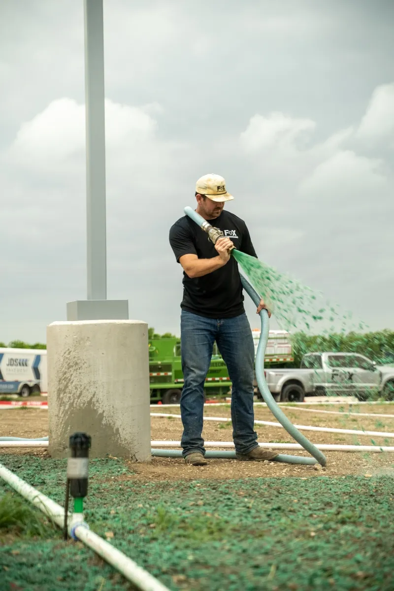 Fox Hydroseeding technician applying hydroseed mix in North Texas