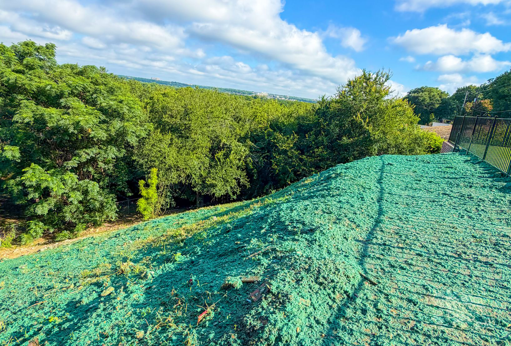 Skid steer soil prep before hydroseeding in North Texas