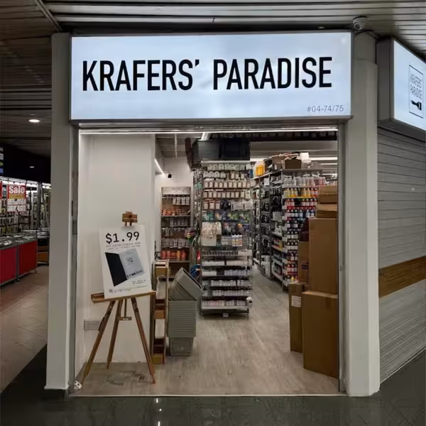 Storefront of Krafers' Paradise showing shelves stocked with crafting supplies.