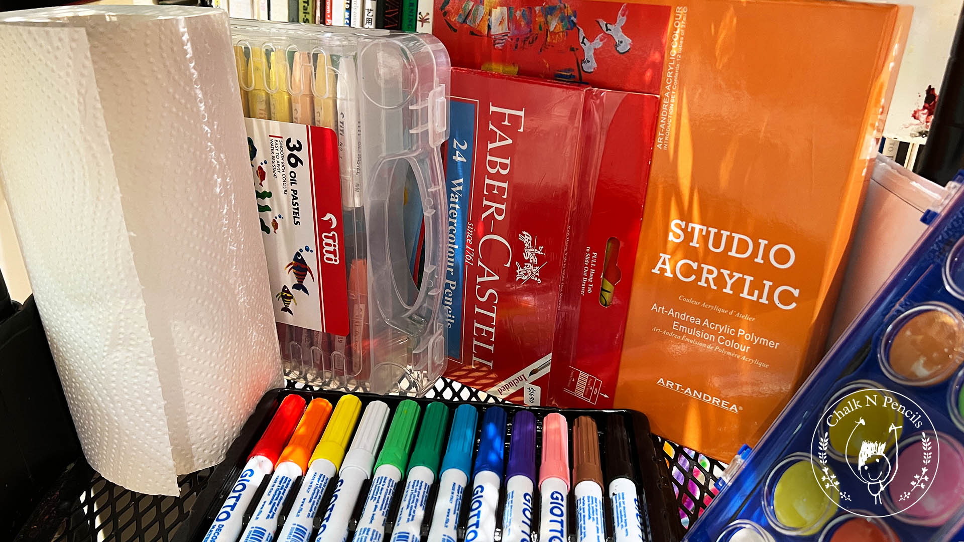 Middle basket of the art trolley holding paints, brushes and glue