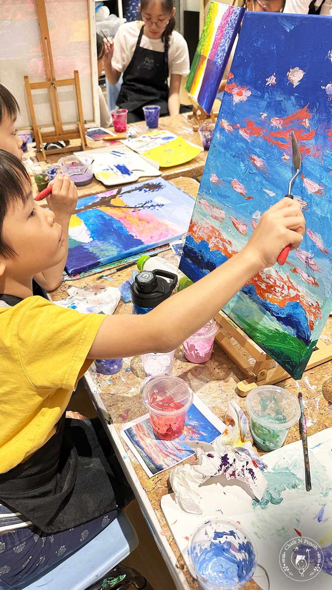 Older child painting with a palette knife