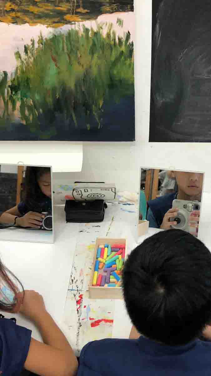 Children working on art side by side at Chalk N Pencils