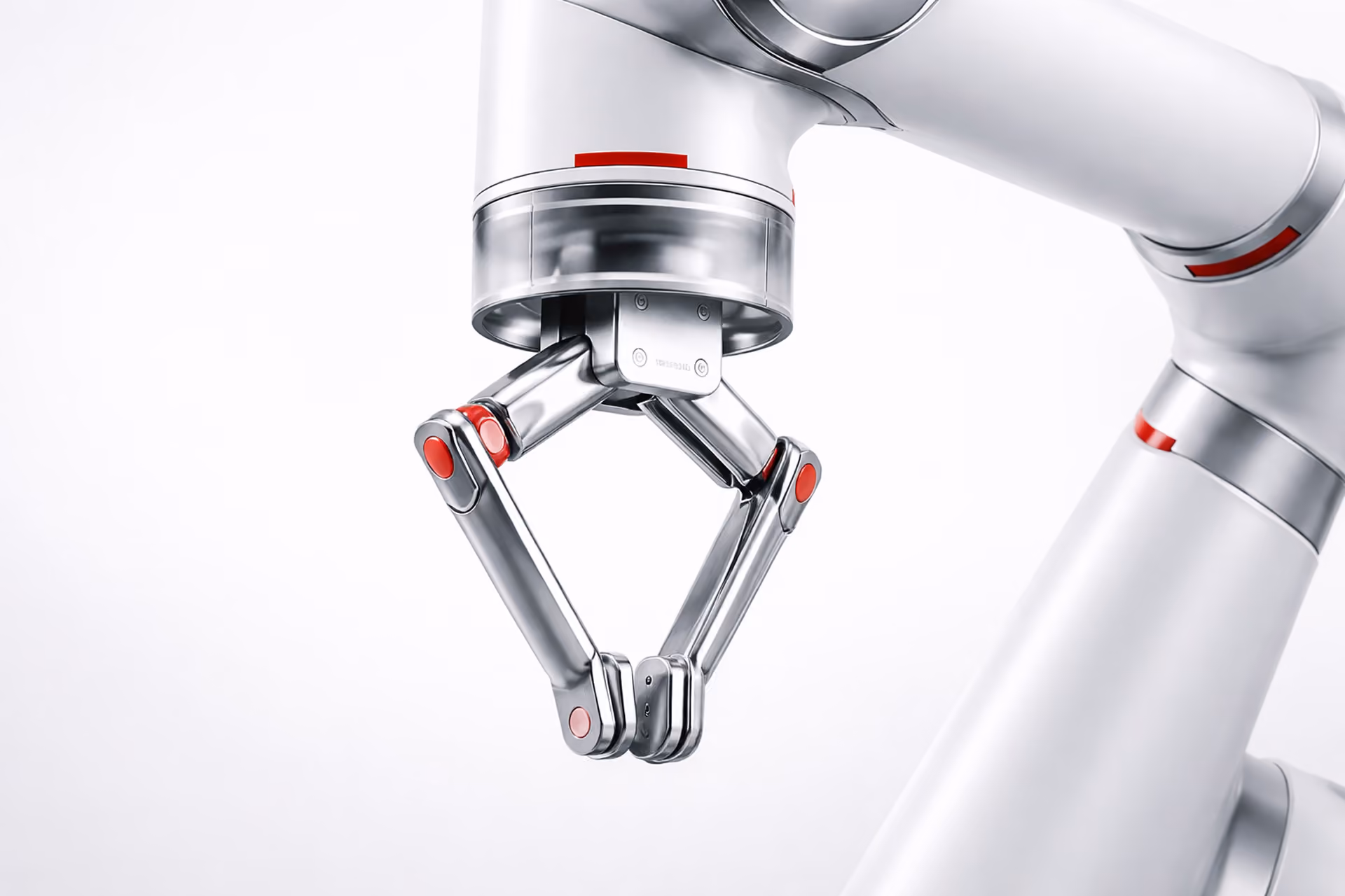White robotic arm with a metallic gripper reaching to pick up an object