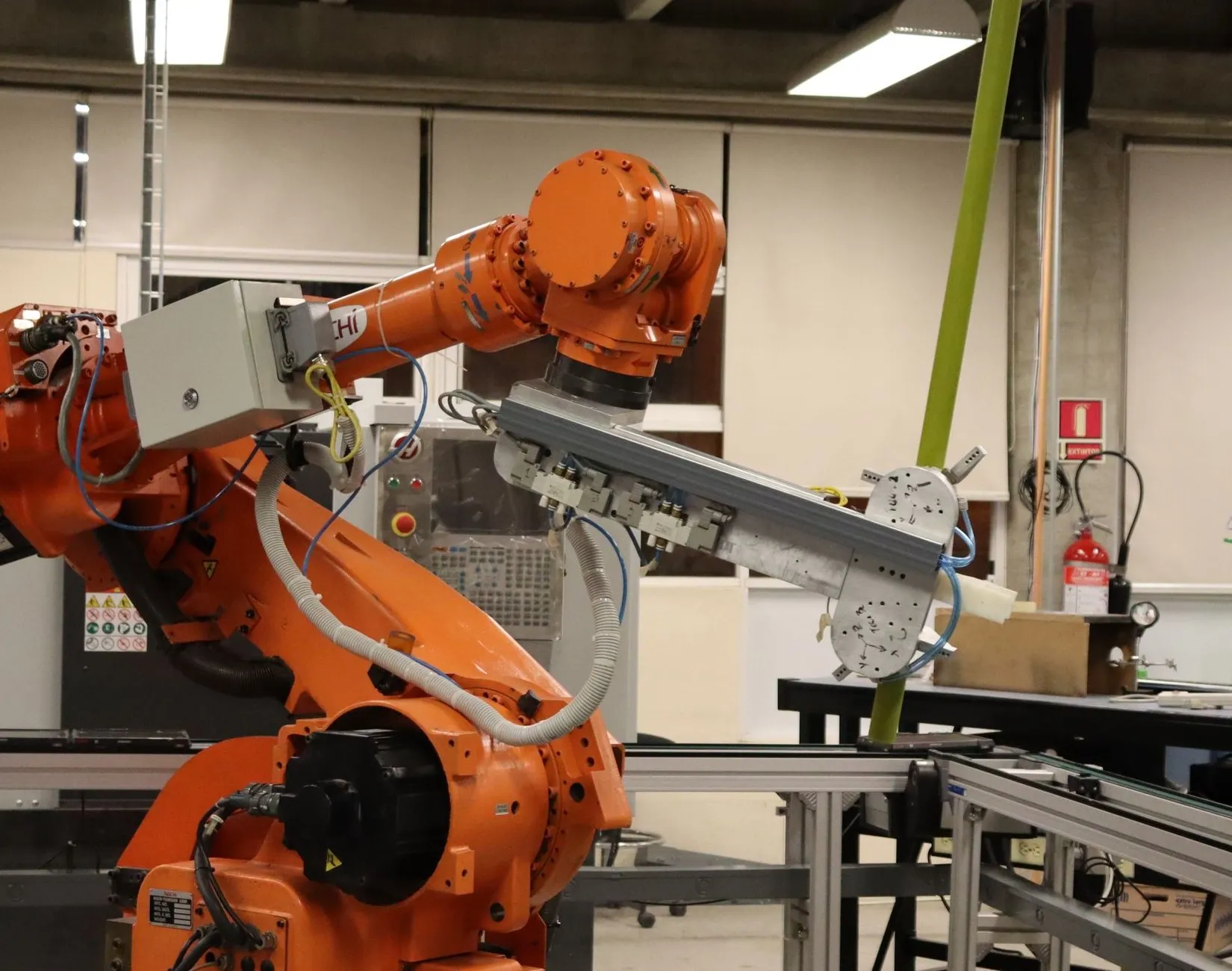 Six-axis robot arm with a vacuum end-effector in a lab