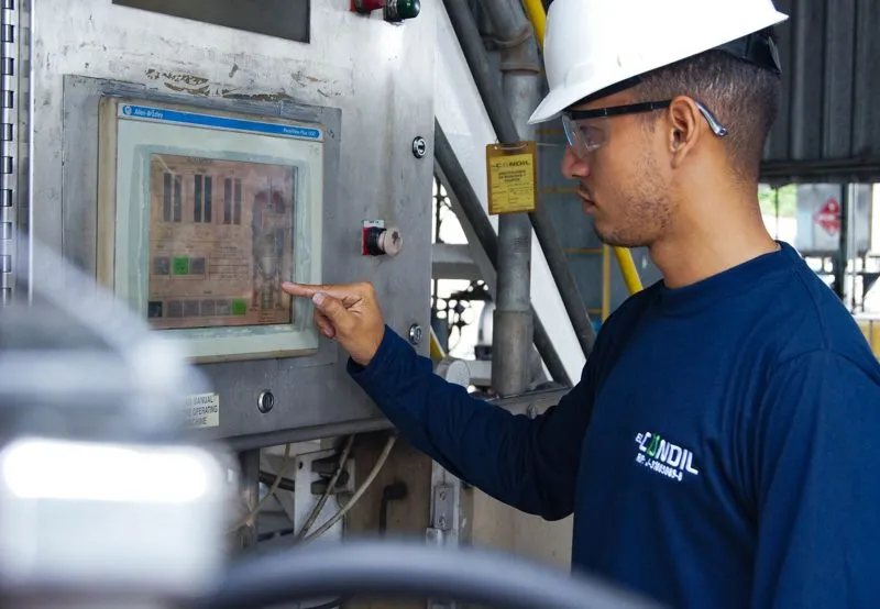 Engineer operating a machine control panel