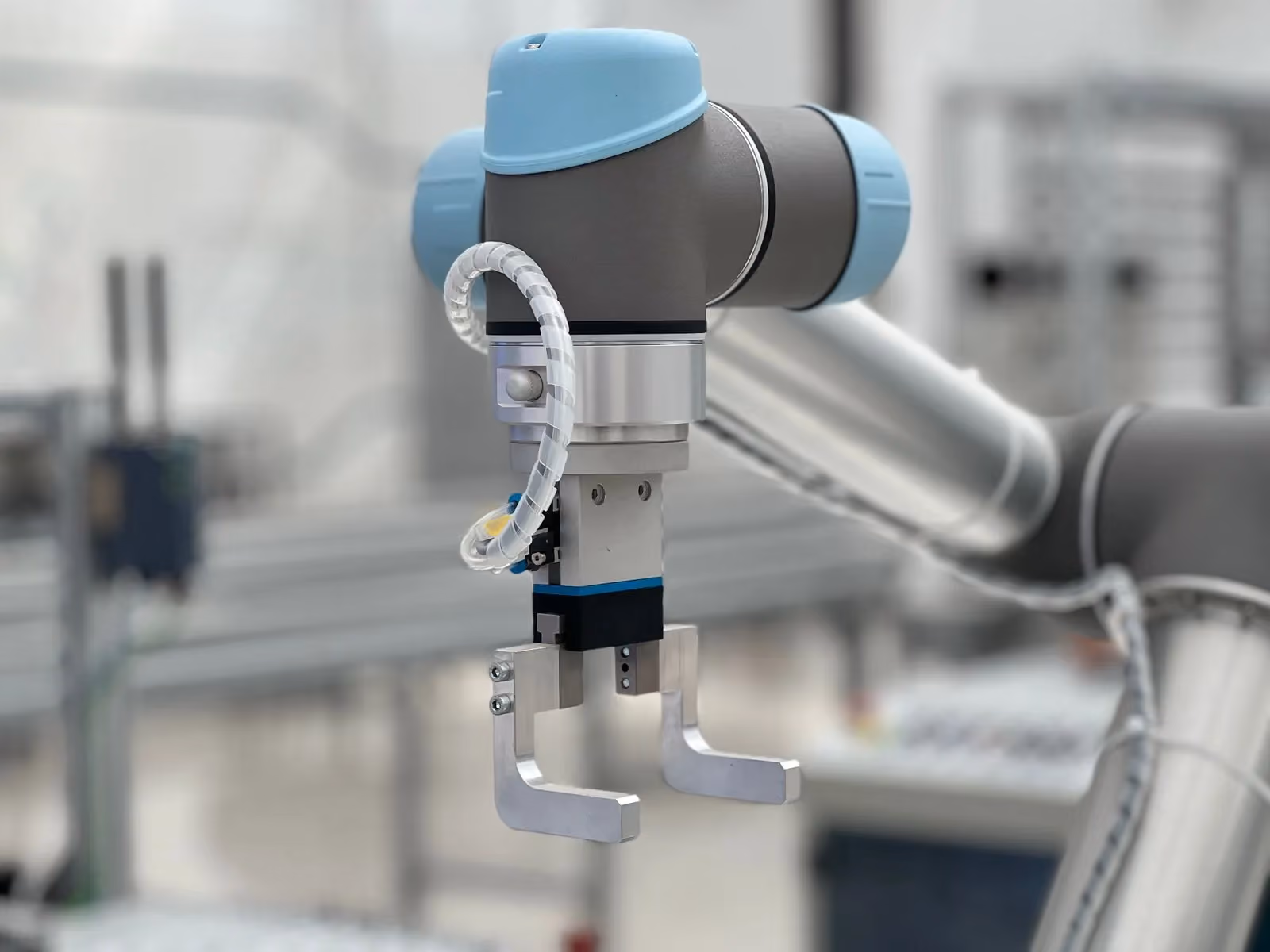 Close-up of a cobot wrist and gripper above a work surface