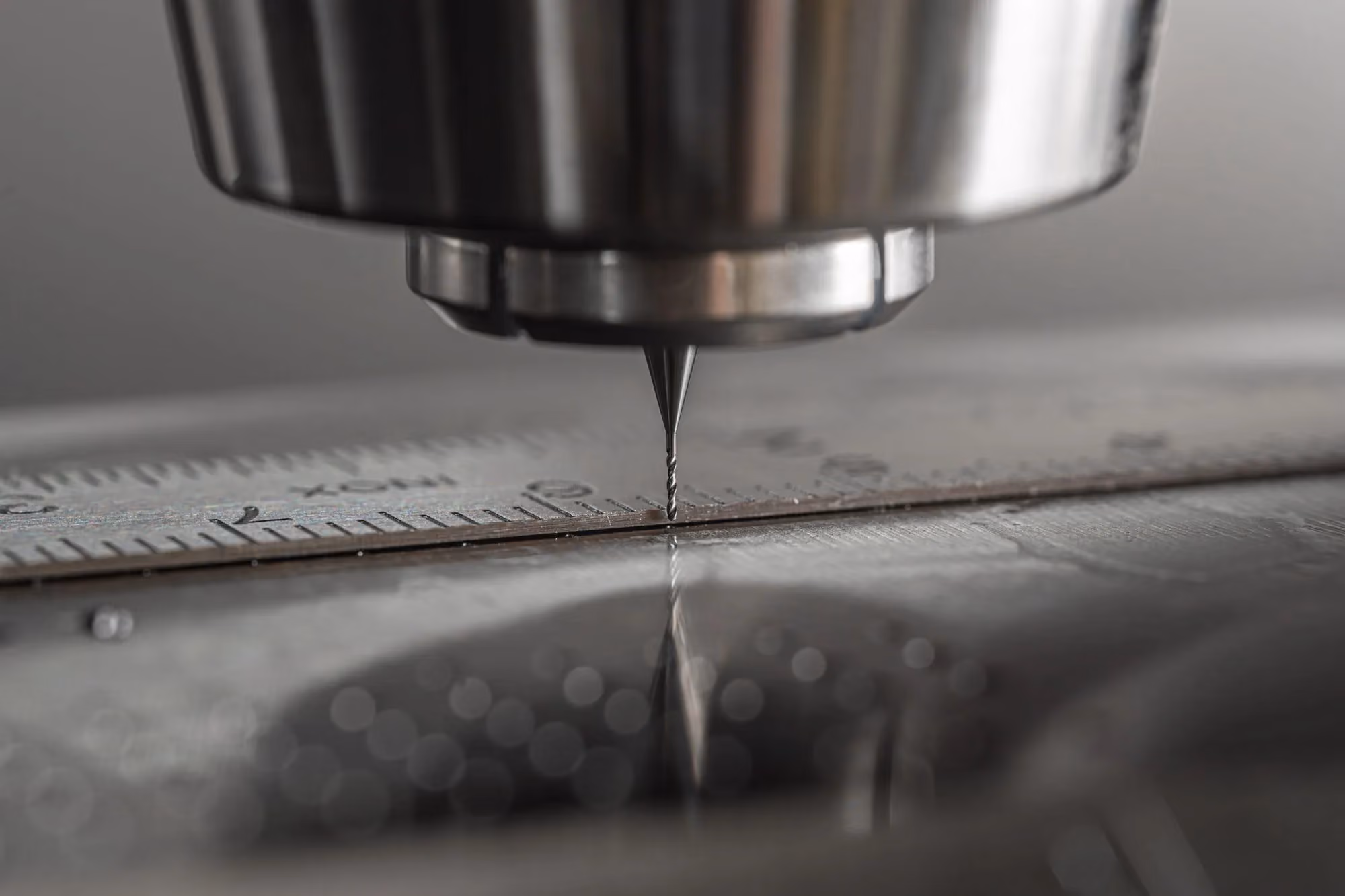 CNC milling spindle cutting a metal workpiece under coolant