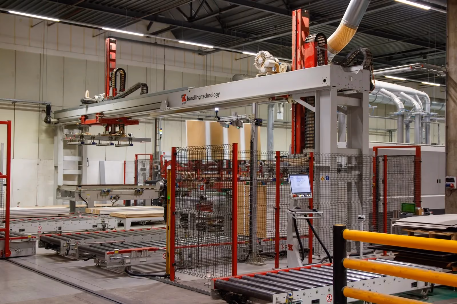 Industrial machinery with a robot arm working inside a manufacturing cell