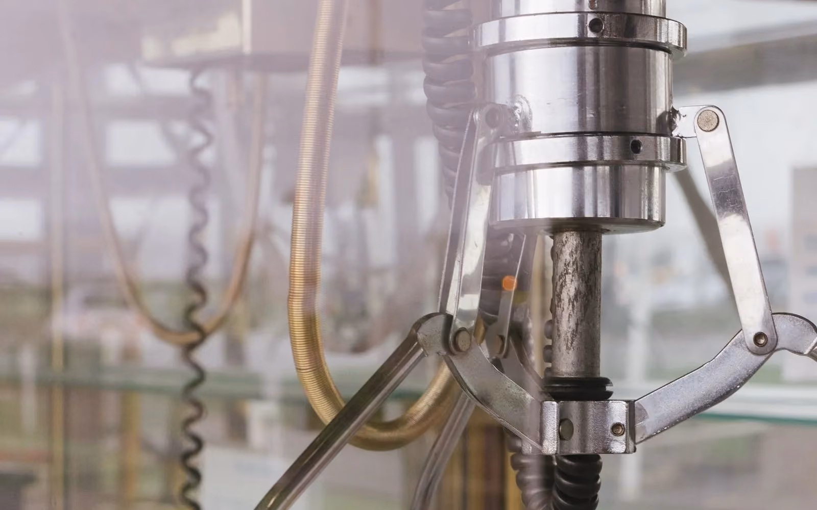 Close-up of a pneumatic gripper head with its jaws open
