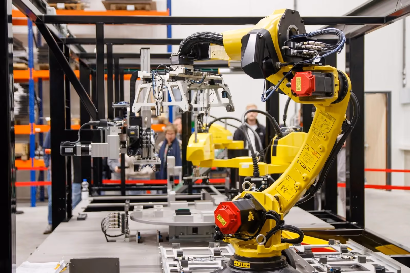 Six-axis robot and vacuum tooling mounted inside a framed work cell