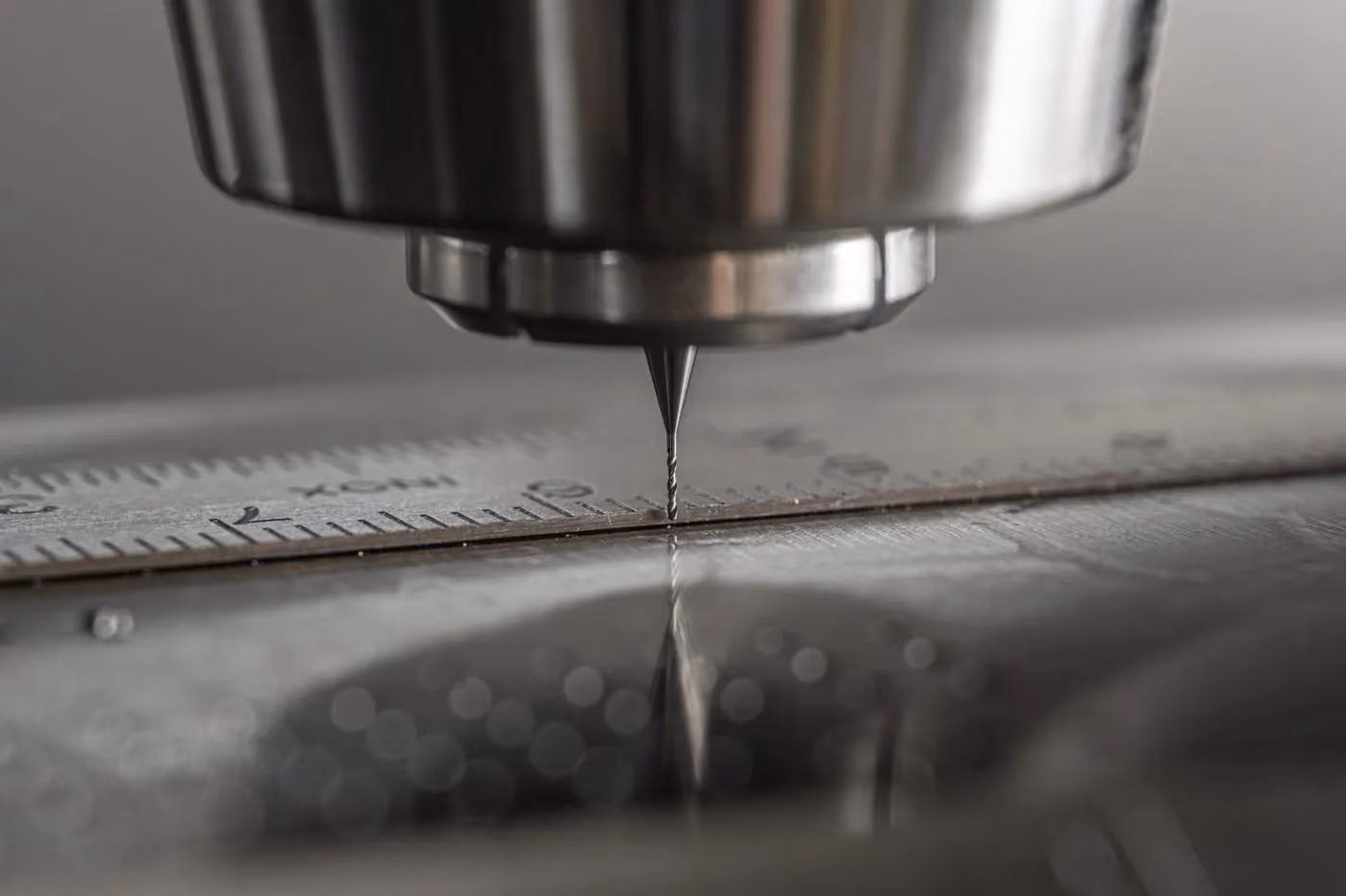 Precision cutting tool working a metal part on a machining bed