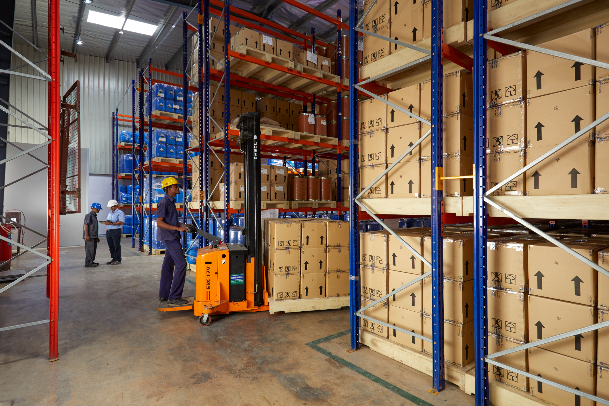 Large chemical warehouse with pallet racking, forklift and packaged products ready for global dispatch.