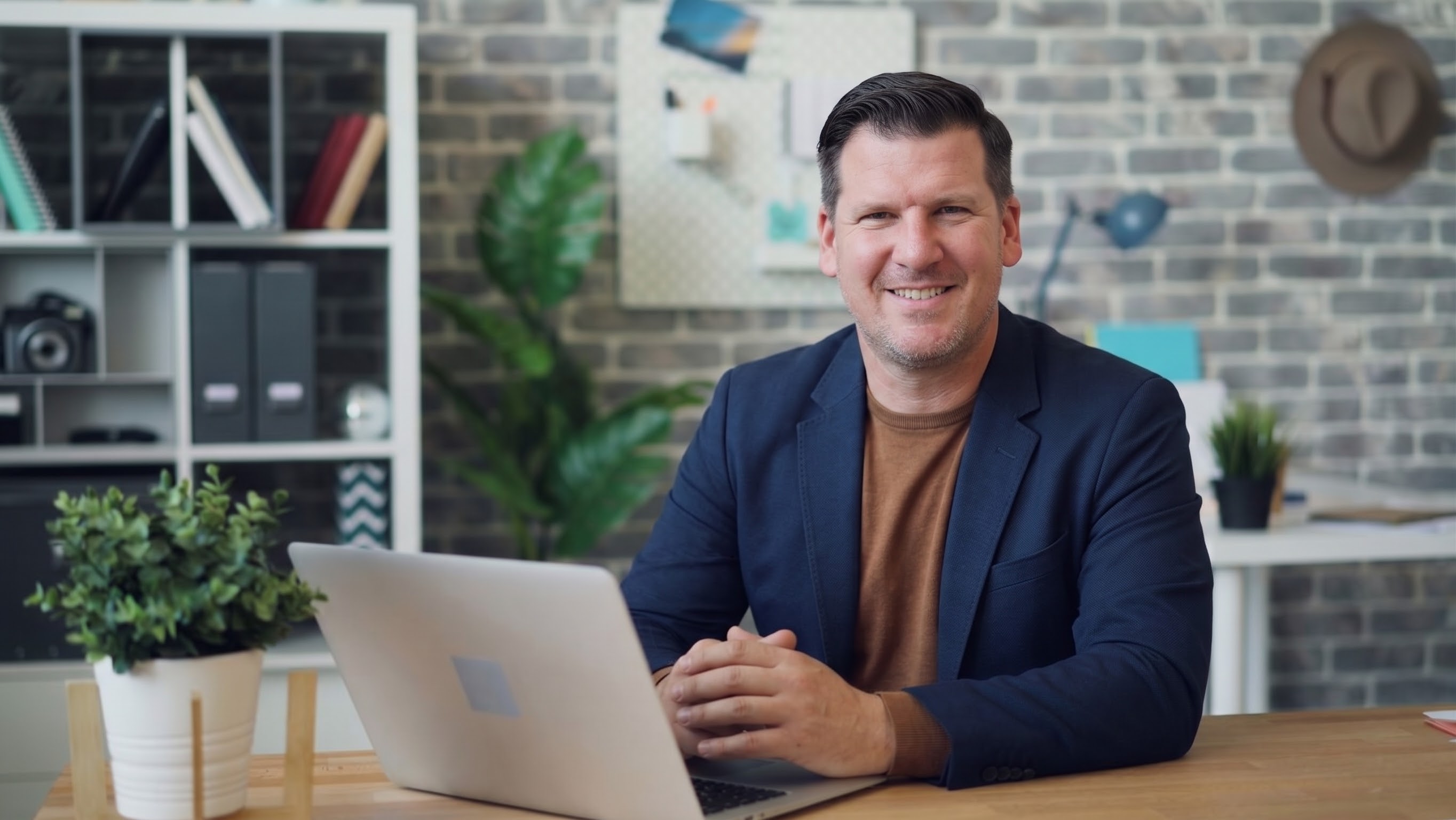 Ryan at his desk with a laptop