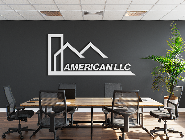 Modern office meeting room with mesh chairs, wooden table, laptops, and American LLC logo on dark wall.