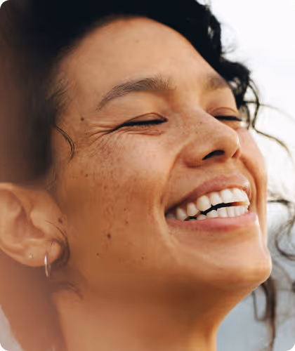 Woman smiling with eyes closed