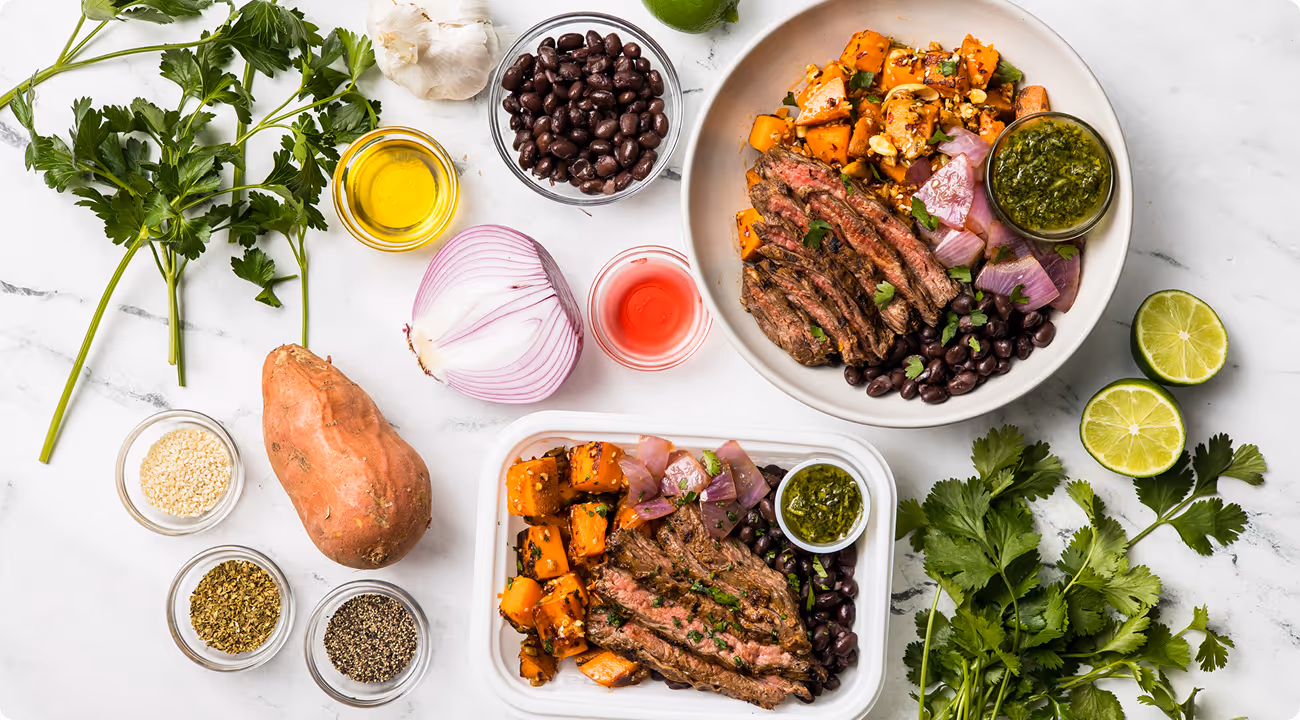 Grilled steak bowl meal prep with roasted sweet potato, black beans, chimichurri, and fresh herbs