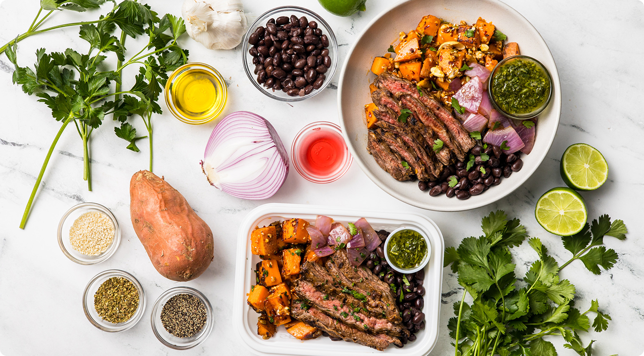 Grilled steak bowl meal prep with roasted sweet potato, black beans, chimichurri, and fresh herbs