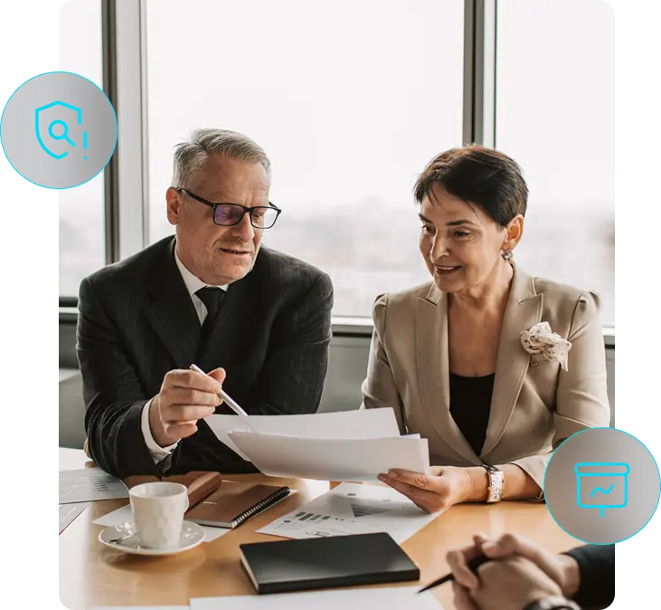 Two business professionals reviewing ISO implementation documents in a client meeting