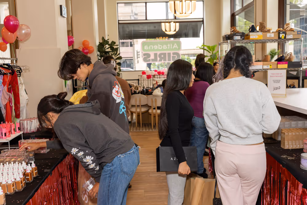 People browsing beauty and skincare products at a lively indoor market or store.