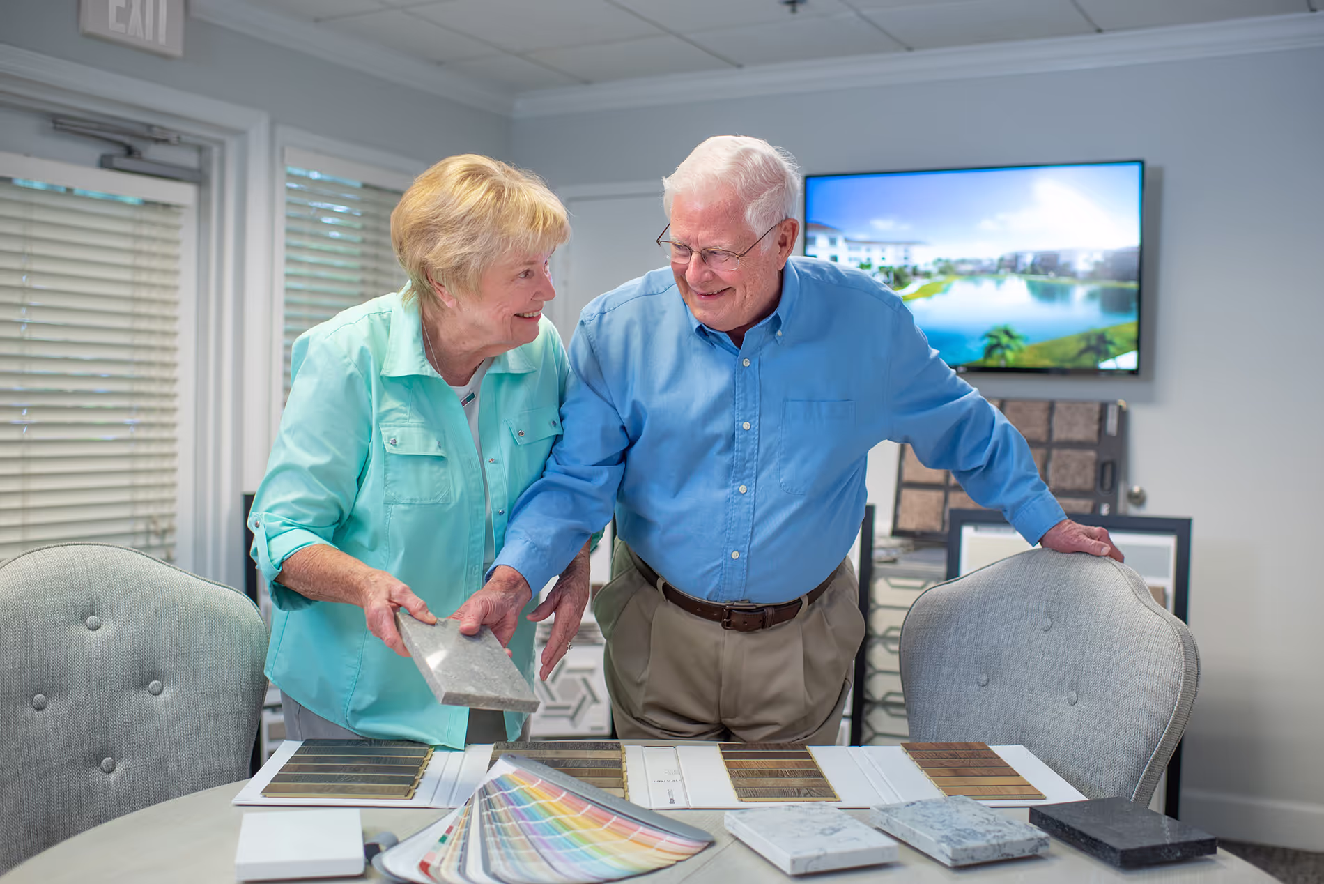 Couple reviewing house finishing samples, thoughtfully selecting colors and materials for their new home together.