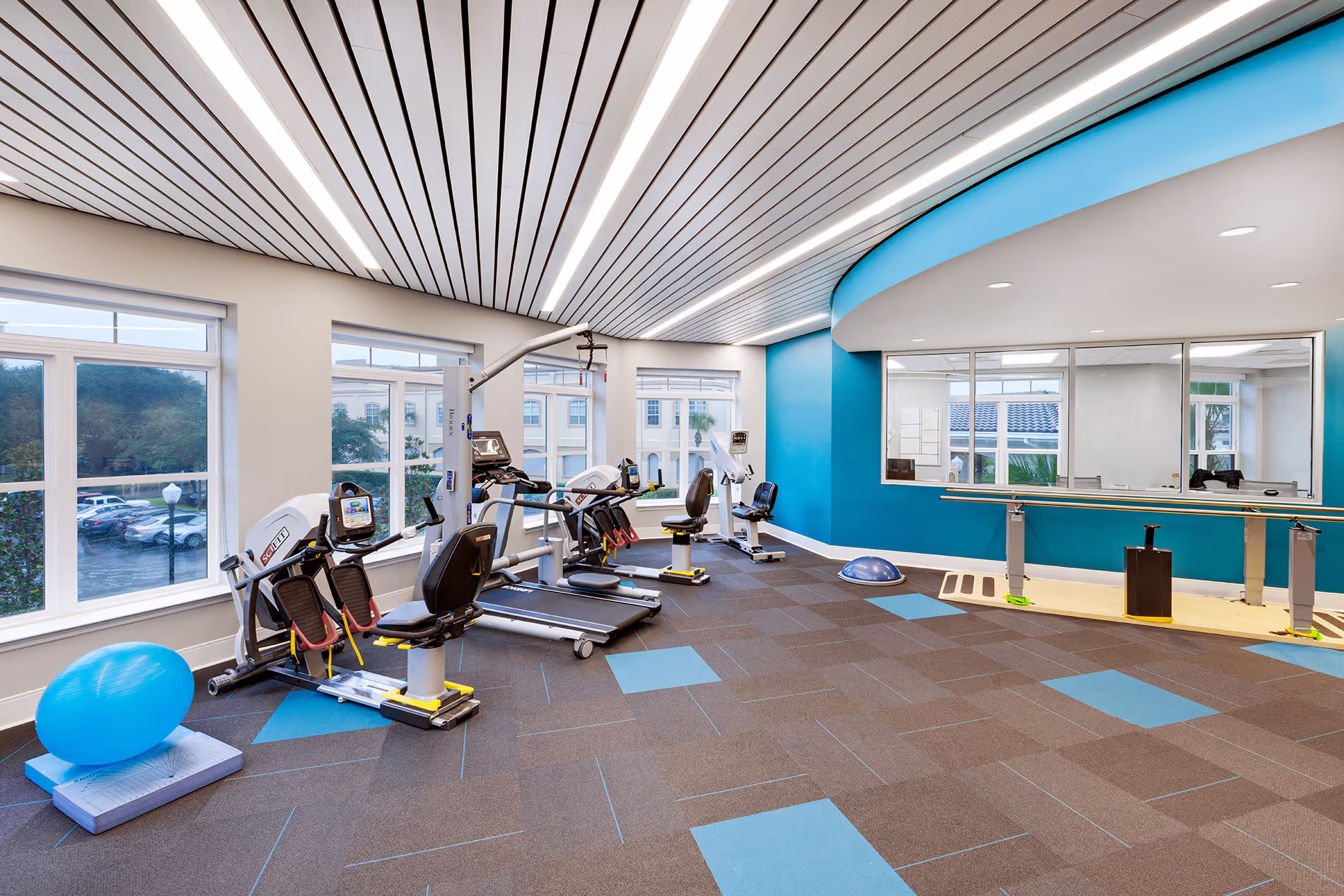 Well-equipped physical therapy room with exercise machines, therapy tools, and a clean, spacious environment designed for rehabilitation and recovery.