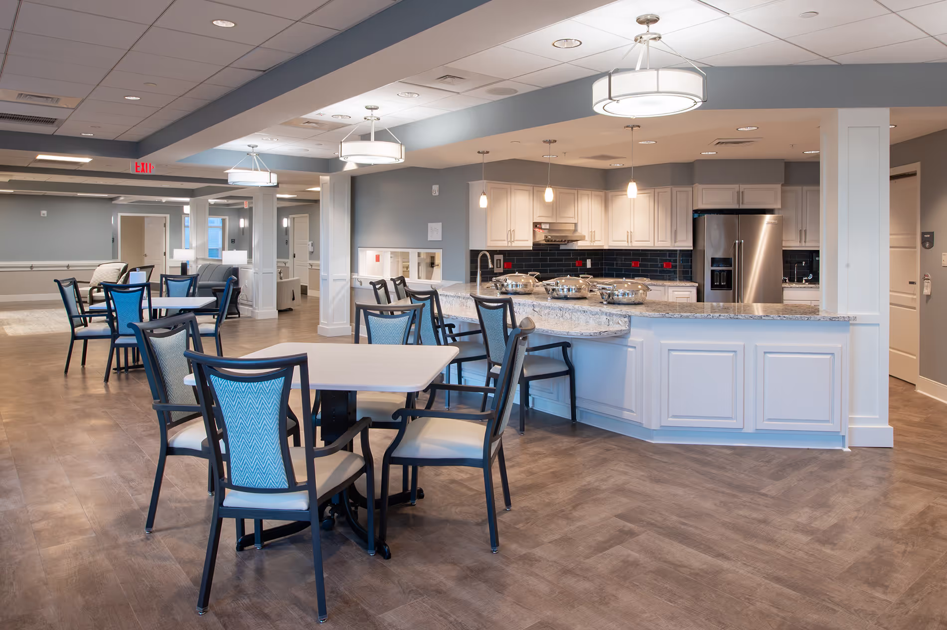 Assisted living dining room on the retirement community campus, designed with cozy seating, accessible layouts, and a welcoming atmosphere for residents.
