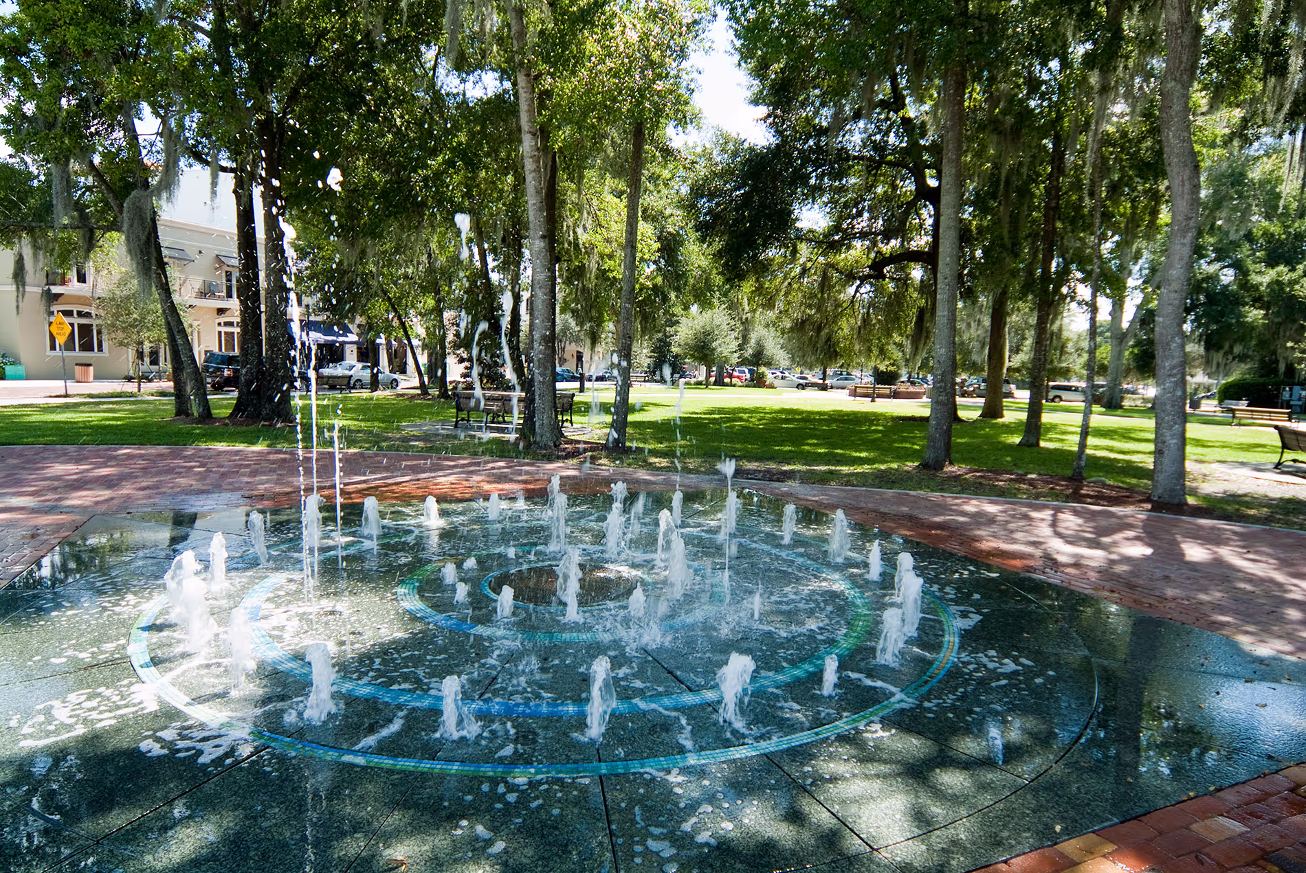 Elegant fountain in downtown Winter Park, Florida, surrounded by brick walkways, greenery, and a peaceful public space.
