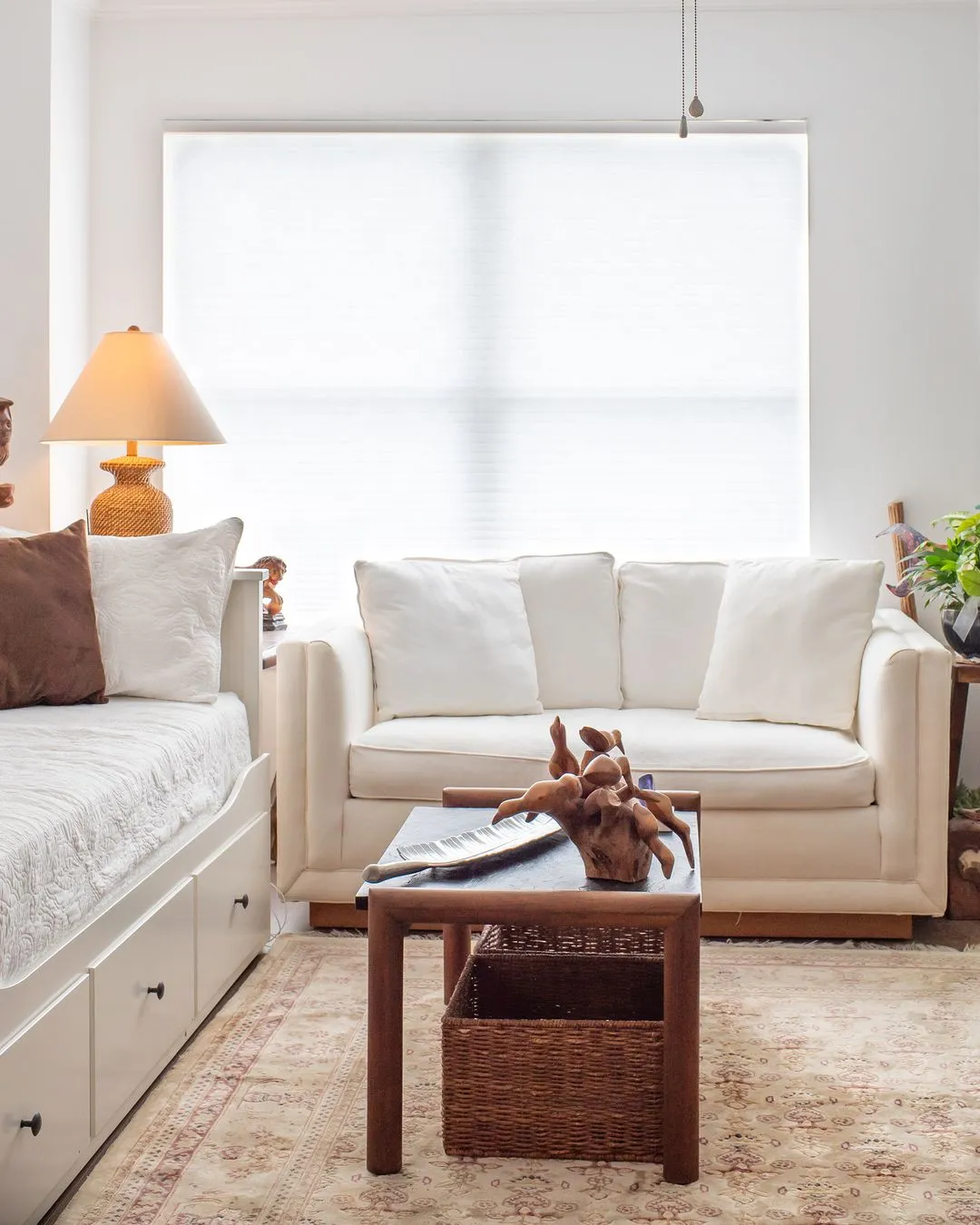 Clean and minimalist living room with modern furniture, neutral tones, and a cozy, inviting atmosphere.