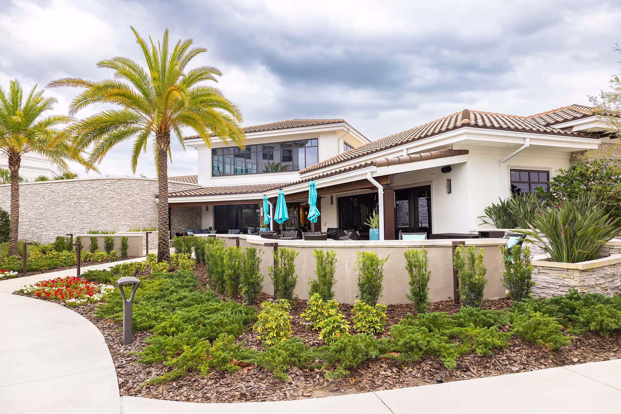 Clubhouse on the retirement community campus, featuring inviting architecture and surrounded by well-kept landscaping.