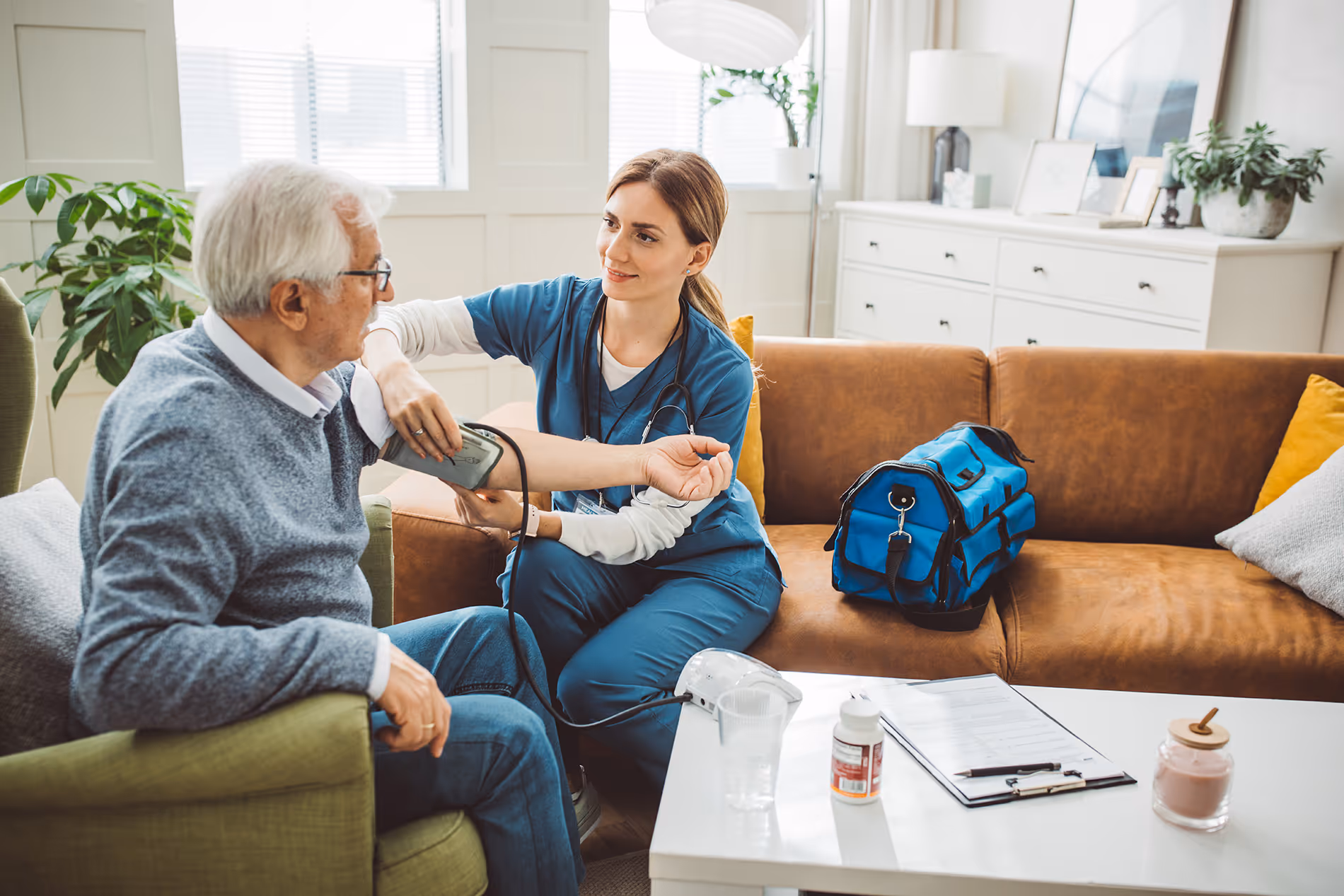 Nurse supporting an older man in his home, creating a warm and caring environment.