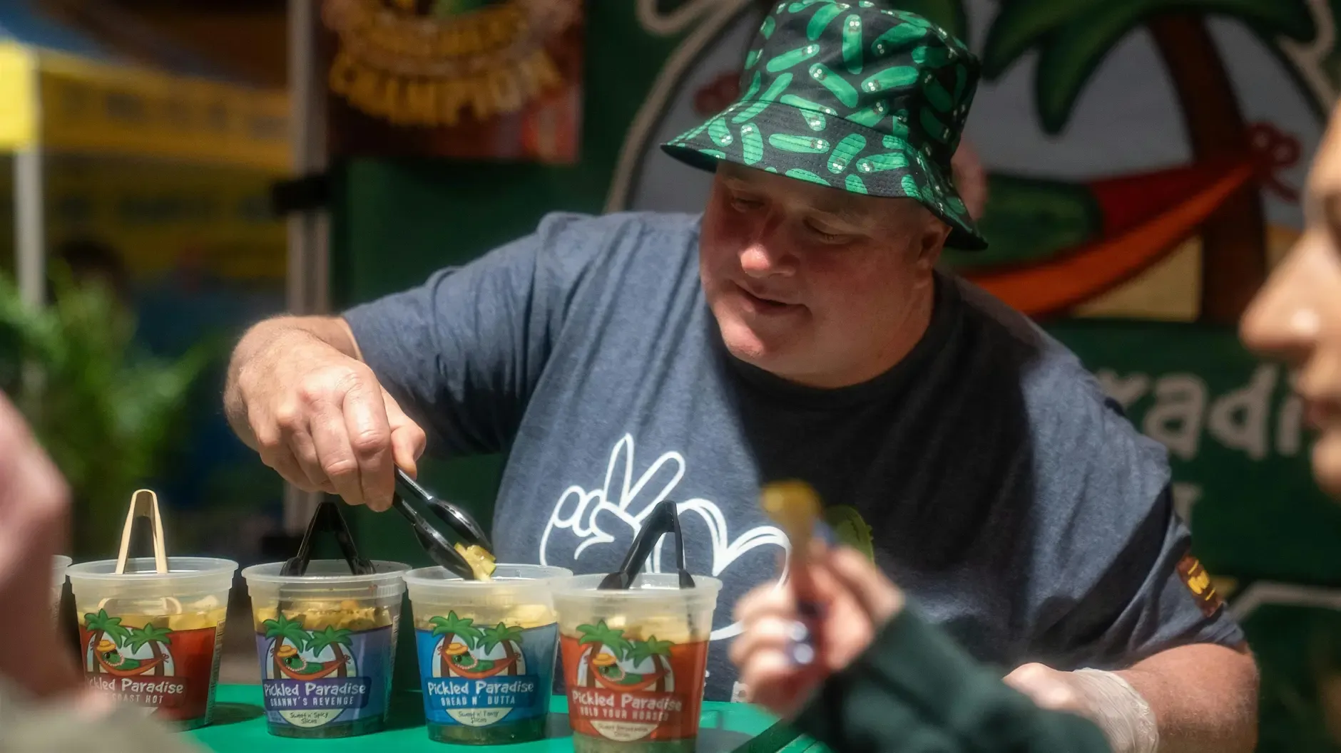 Vendor preparing pickle samples at Pickle Wars