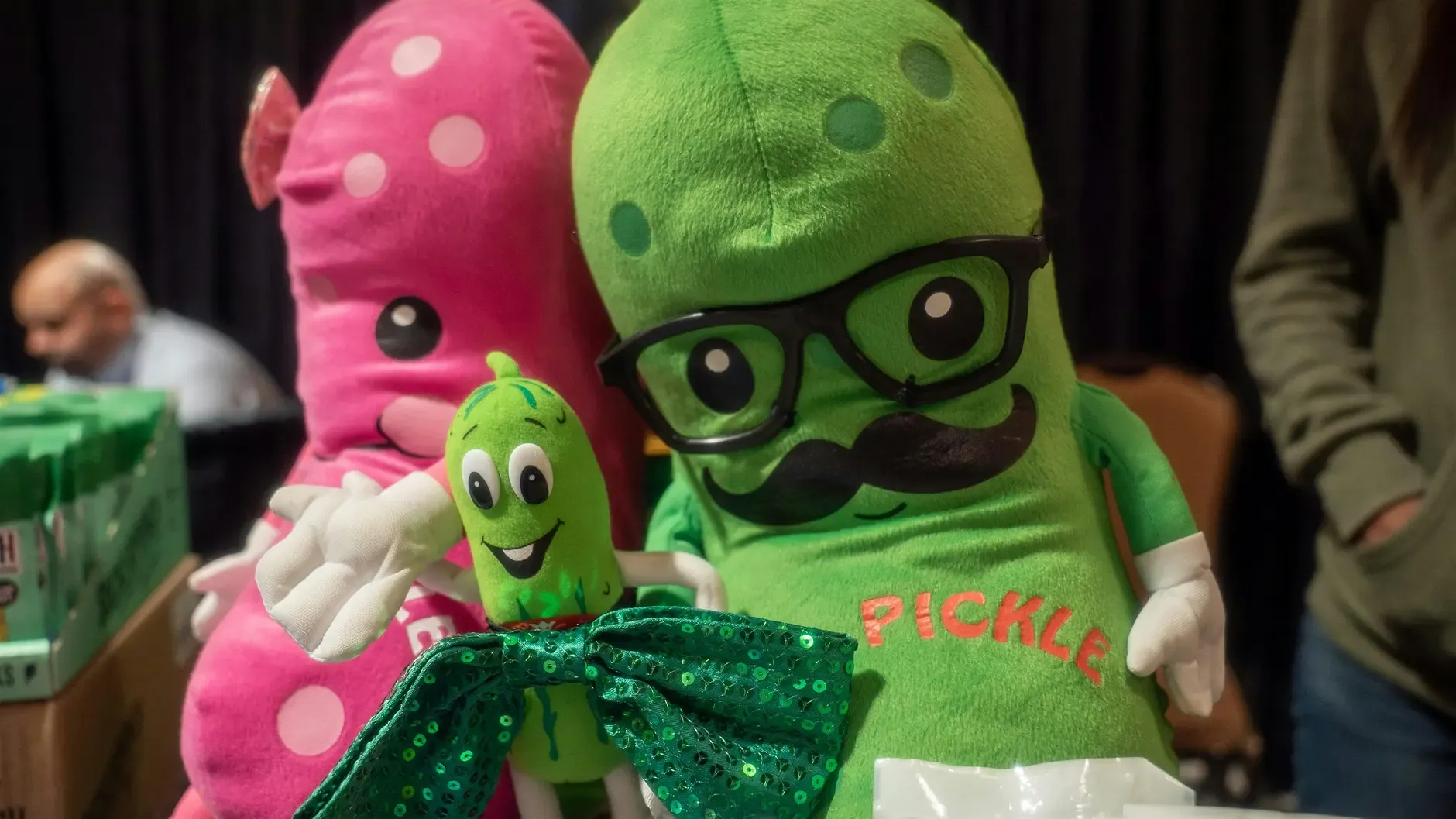 Colorful pickle mascots at the Pickle Wars festival