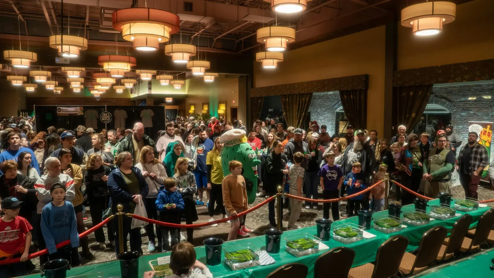 Crowd gathered around the Pickle Wars competition table