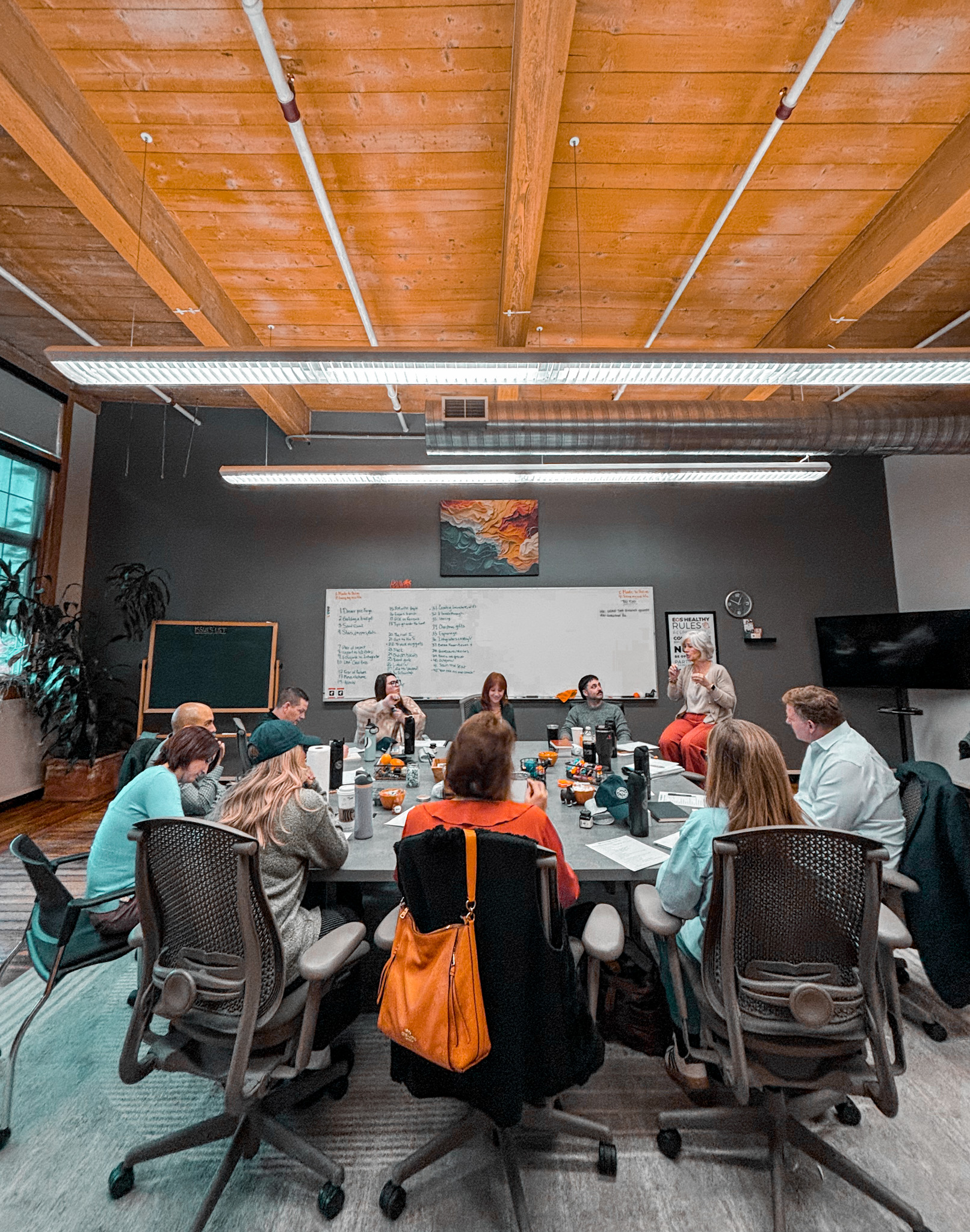 Business leaders gathered around a table for a Beacon & Blade workshop