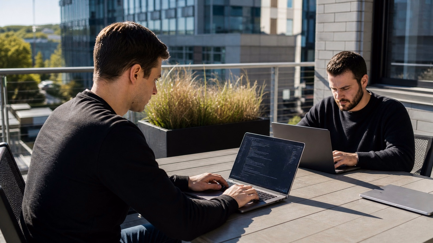 OUTDOOR TERRACE An IT professional one or two people working at a table on a