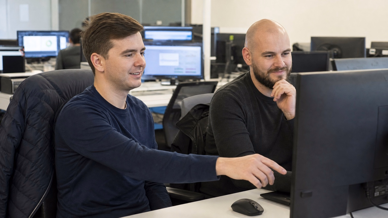 Cybersecurity team analyzing network traffic on monitor