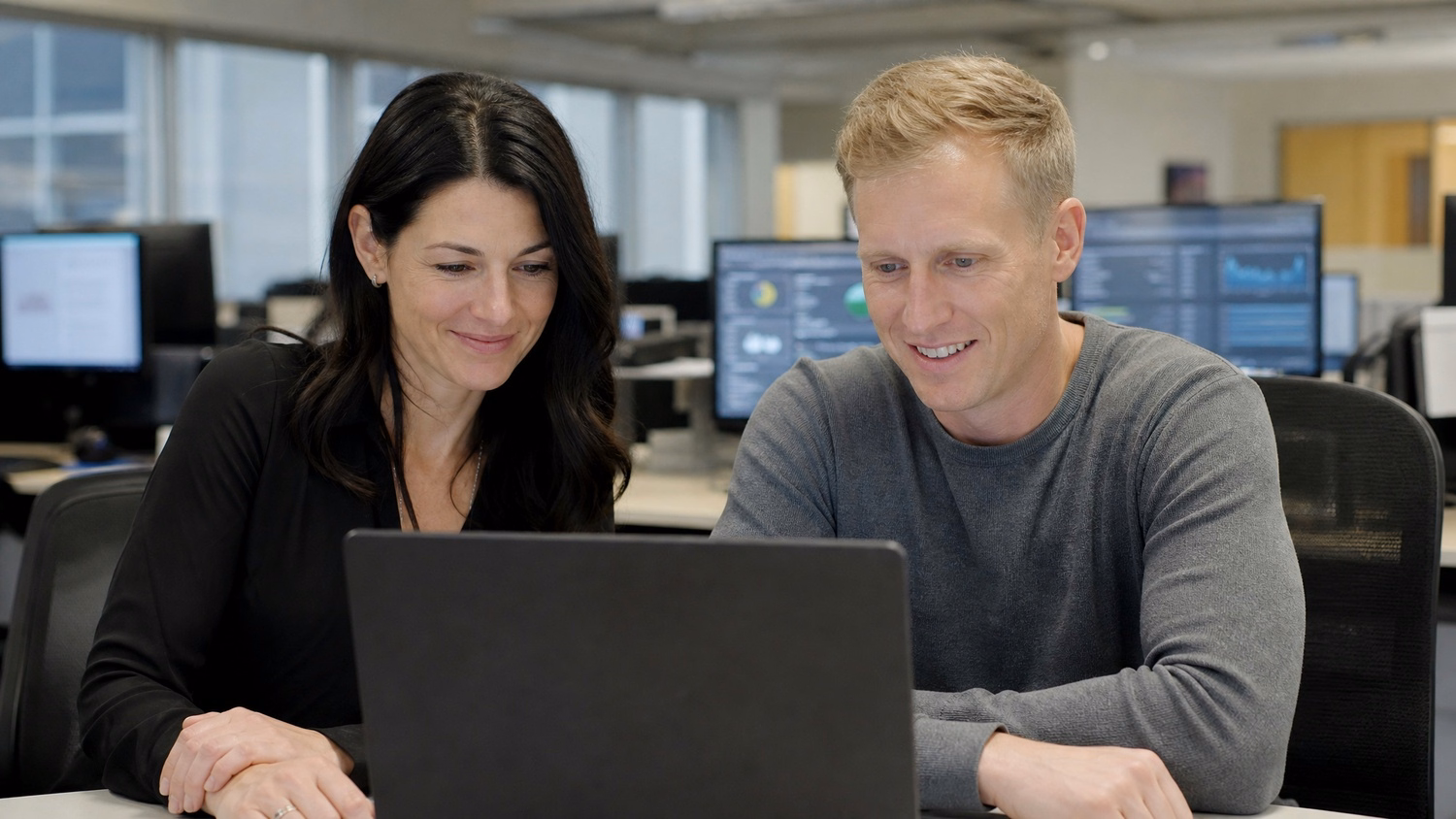 Team reviewing cloud migration progress report on laptop 68 chars