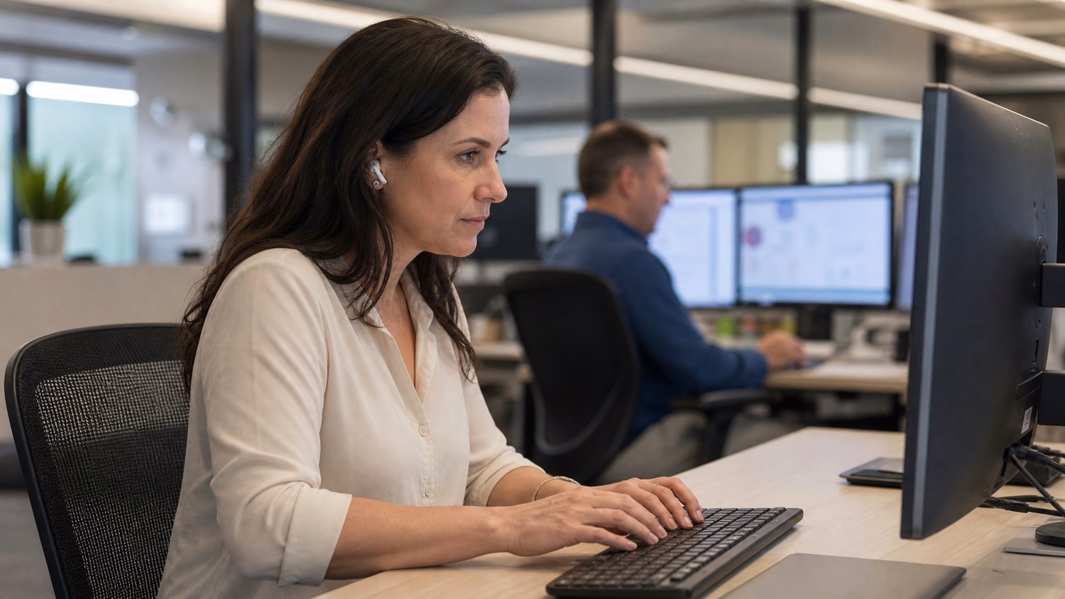 Woman with earbuds restores files on computer monitor 60 chars